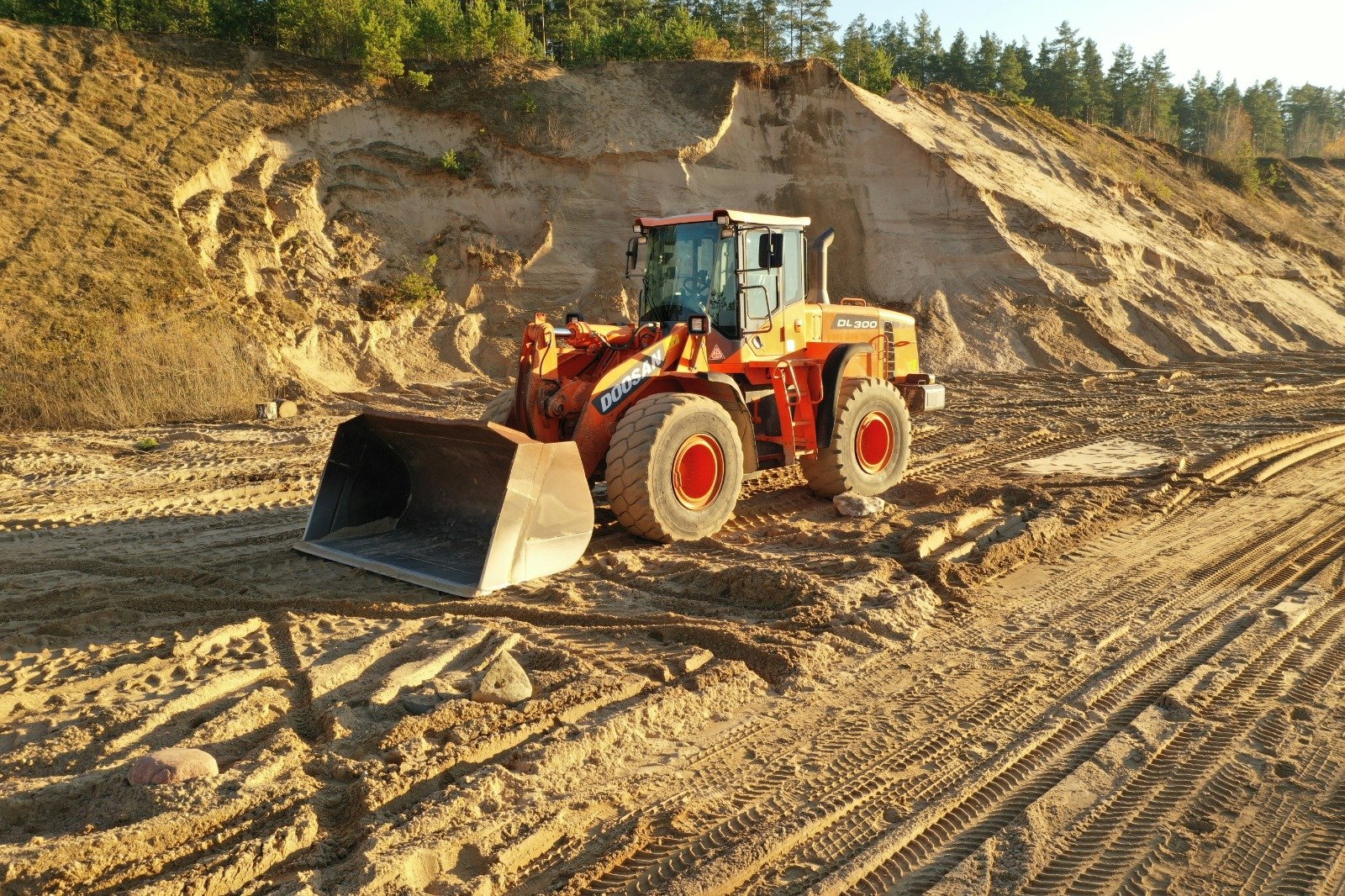 Excavator loading a pipe trench